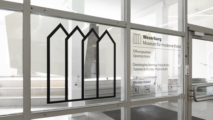 Entrance to the Weserburg, Museum of Modern Art, glass window with opening hours and museum symbol