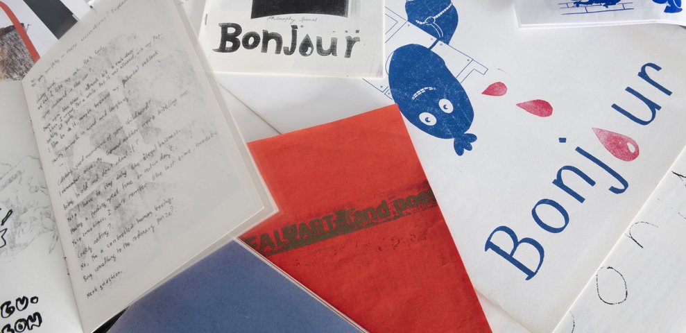 Collection of handmade zines and prints with typographic and illustrative designs.