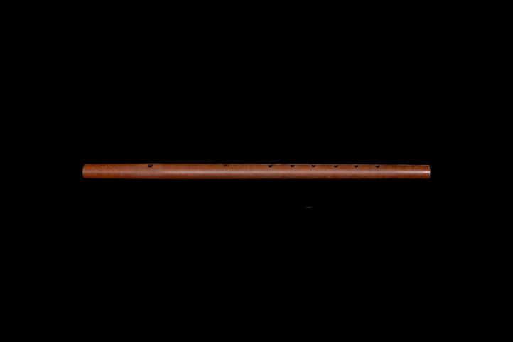 Renaissance traverse flute in light wood against black background.