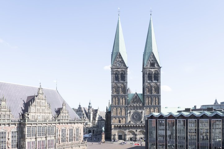 Bremen Cathedral and historical buildings in the market square, clear sky in the background